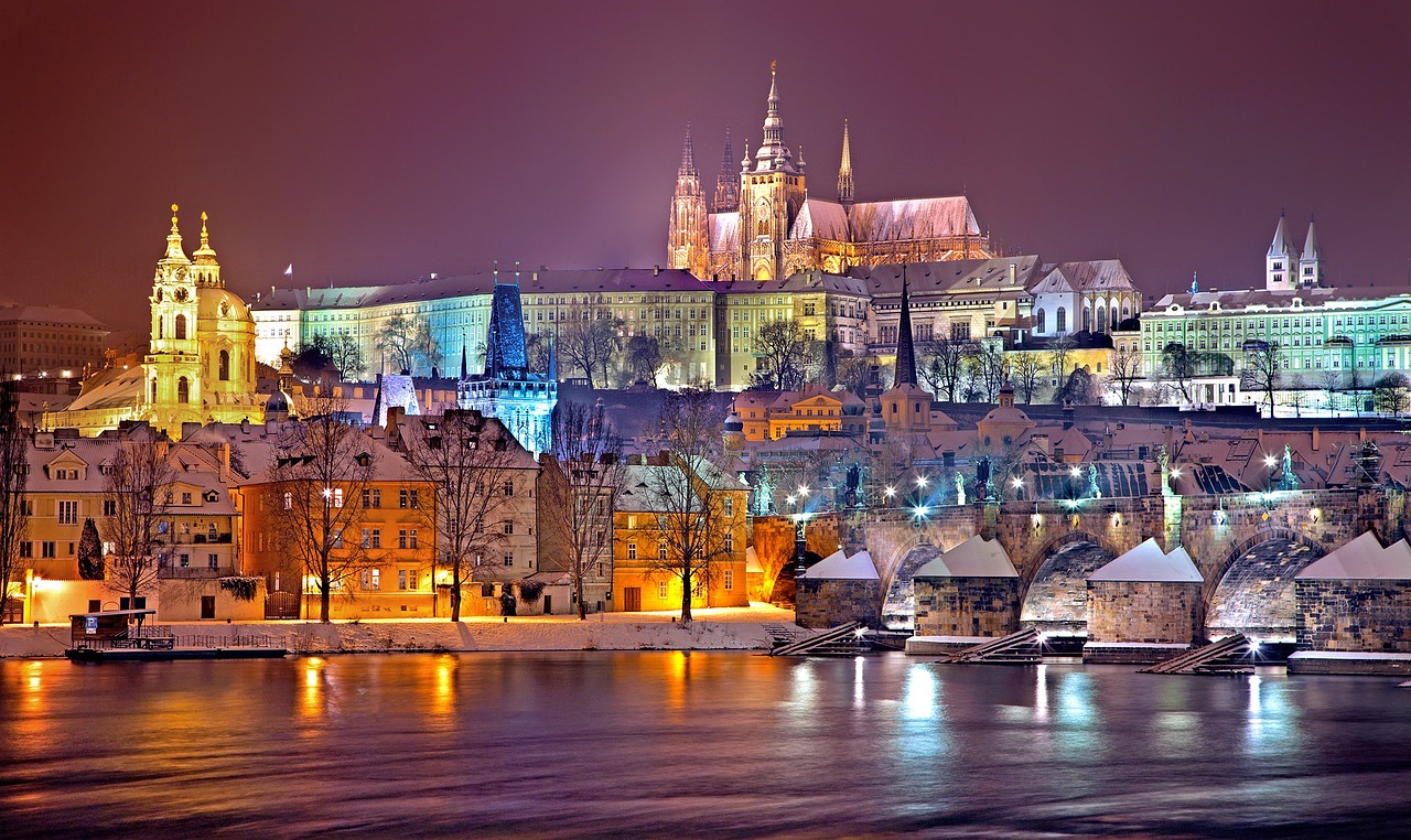 a city with a bridge and snow covered buildings